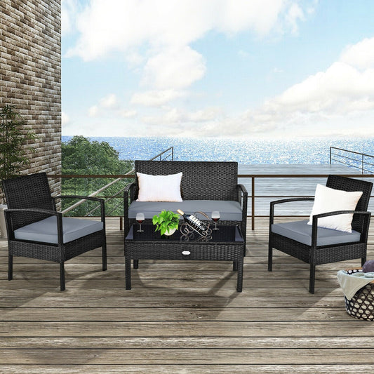 4 Piece Rattan Patio Furniture Set w/ Love Seat + Coffee Table + Grey Cushions.